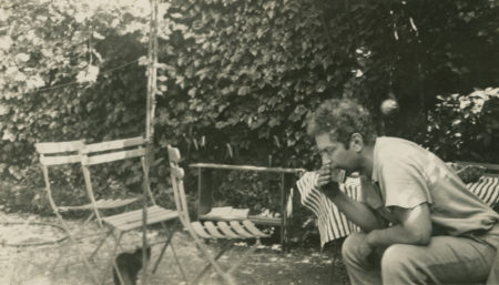 Calder playing the harmonica in the rue de la Colonie garden, Paris (c. 1931)