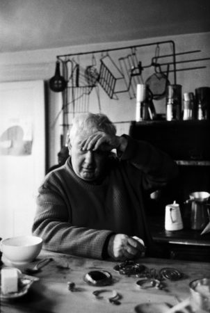 Calder polishing jewelry in the Roxbury kitchen (c. 1958)